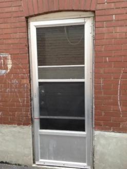 Access to the backyard is provided by a metal door that is complete with a metal