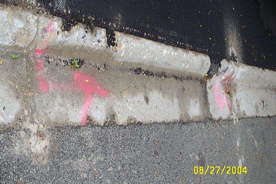 Examples (continued) Figure 9 - Deteriorated Curb, Asphalt Apron The curb should be replaced through the entire