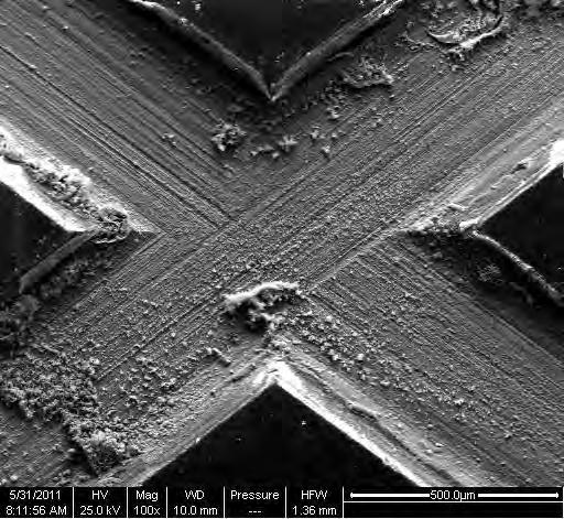 Blistering of the protection scheme can be seen along scribe lines, although not shown in SEM image.