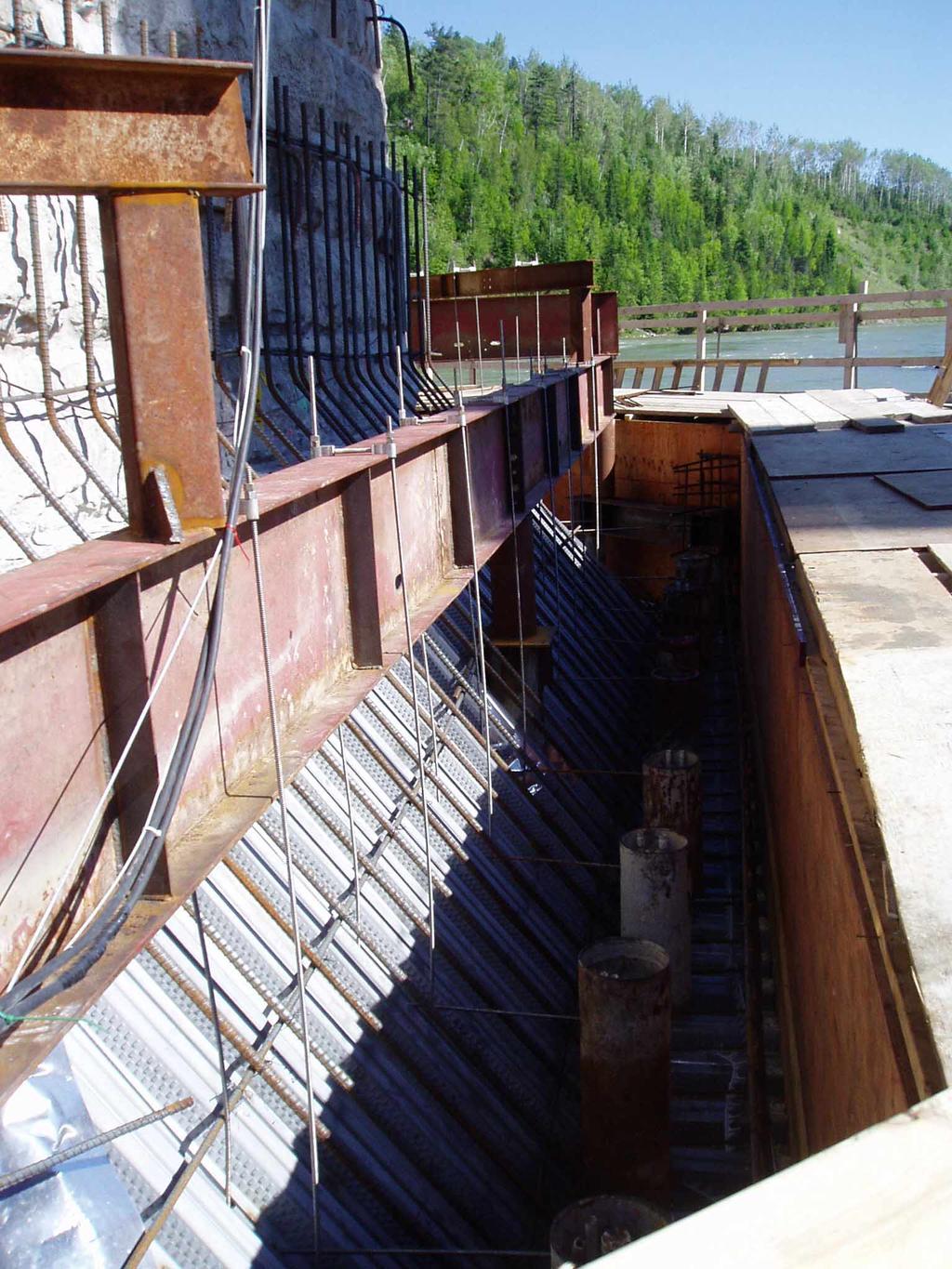 was used as the bottom form (see Figure 14). The bottom tip of the steel decking was supported on angles that were welded to the micropiles.