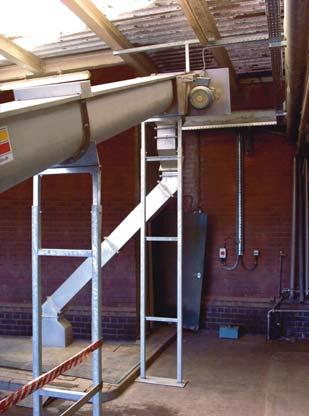 Three in-line pneumatically operated outlets with pneumatically operated brush gear has no side projections, which allowed this conveyor to be fitted as closely as possible to the