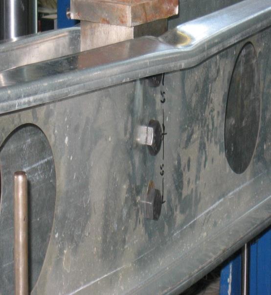 9: Failure mode of Test 1 by bending of top flange and local failure at connection between beams and steel blocks A maximum deflection of 1 mm was recorded at failure and te maximum resistance
