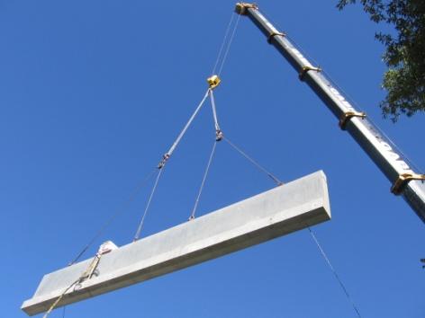 a.) Crane Lifting HS-SCC Bridge Girder b.) HS-SCC Bridge Girder Being Set during Bridge Erection Fig.