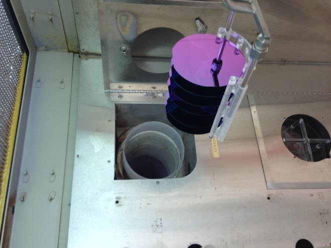 On the right, I am pulling the wafers out of the chamber, note that they are loaded on a quartz boat and that they look violet from an angled view, this is evidence that the oxide thickness is