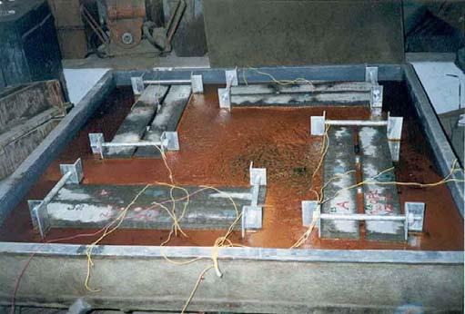 The coating material was applied over the surface of the rebars with a brush and was allowed to cure.