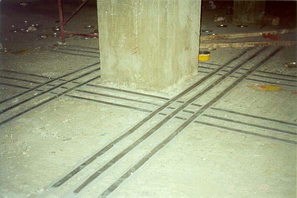 Figure 10 CFRP strips attached to the top surface of concrete CFRP plates bonded to the bottom surface of the slab had enough development length; while the plates bonded perpendicular to the edges of