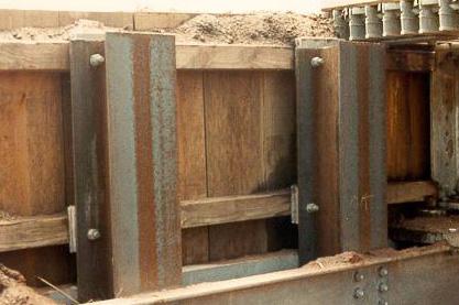 SLIDE #4 * Abutment wingwall with 2 H-pile. Currently, only the outermost pile is used. * Steel channel caps bolted to the H-pile.
