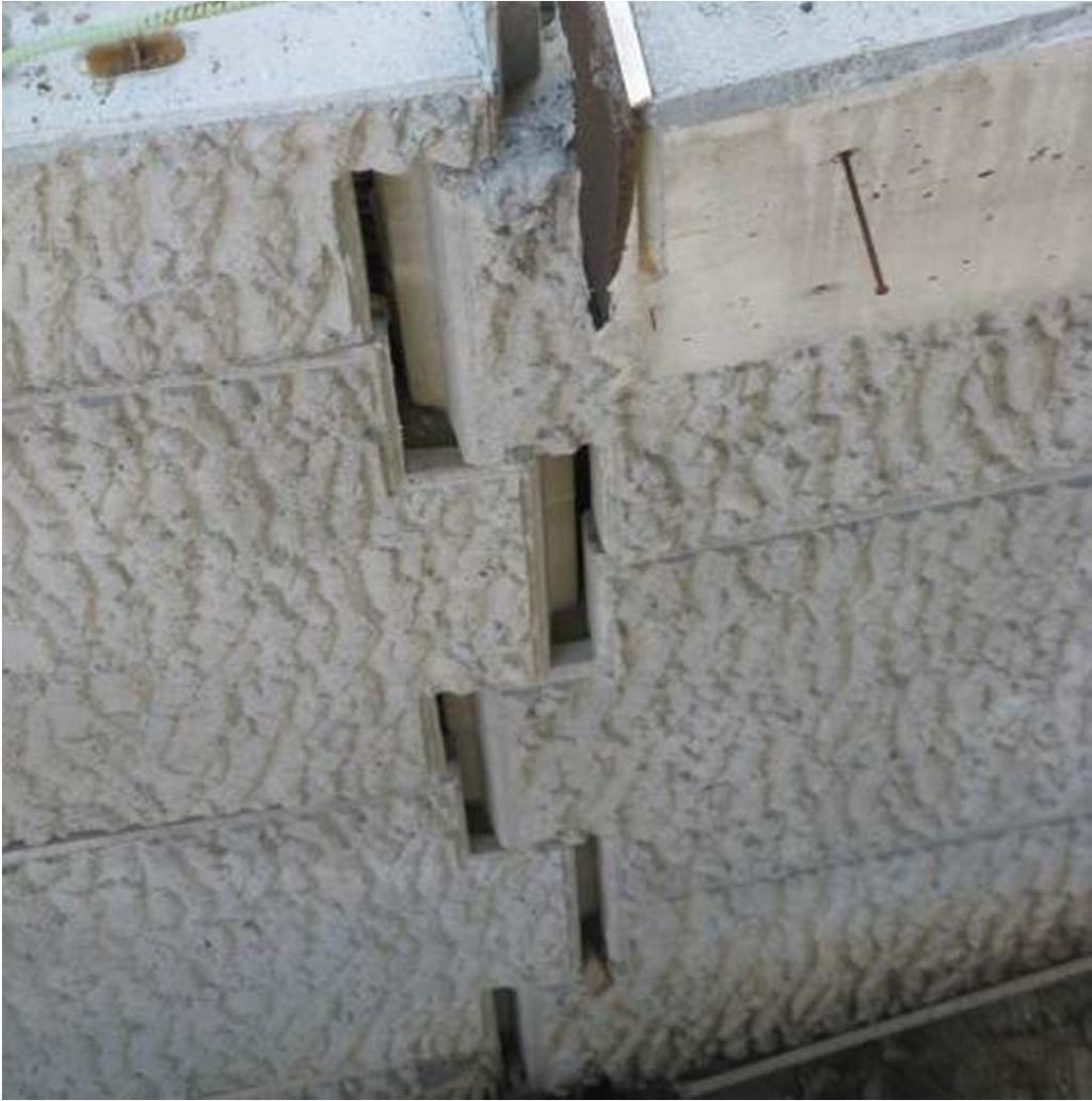 Joint Spacing Two adjacent sections of this wall are bowing outward, causing excessive joint spacing between two adjacent panels.