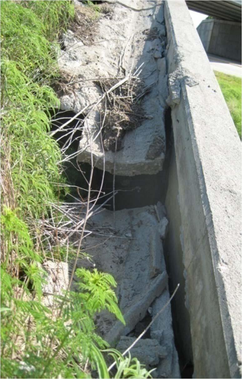 Condition of V Ditch V Ditch (non functional) Coping Loss of backfill has caused a complete break along the V Ditch as well as its separation from the wall.