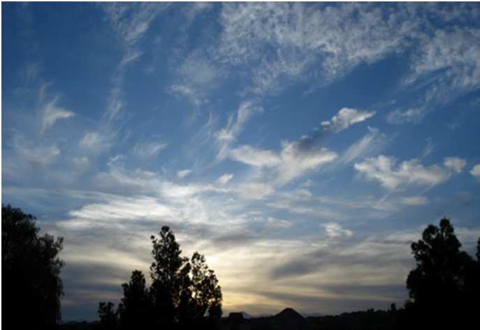 As the atmosphere cools, the water vapor in the air condenses to form clouds, in a process