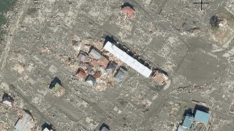 Some timber buildings located just behind a relative large building were survived because the tsunami pressure