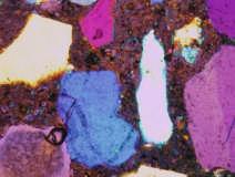 Concrete microstructure with 20% fly ash at 200X magnification. Blue color in paste indicates voids.