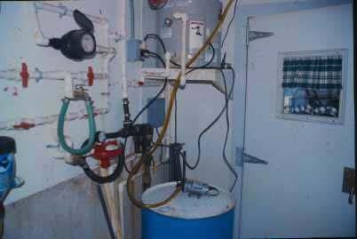 Figure 2. Injection oil pump and storage barrel plus plumbing for oil sprinkling system. Figure 3.