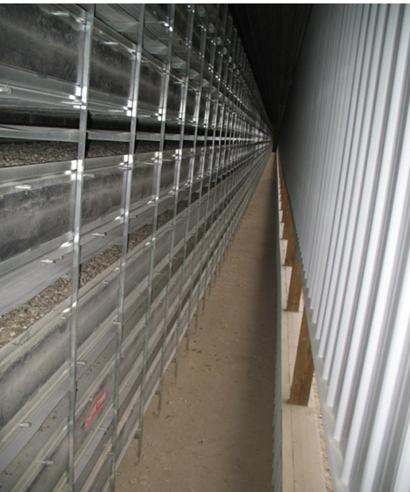using manure-drying air duct situated between the cage floor and the manure belt.