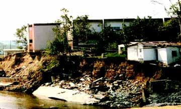 Figure 3-8 illustrates a home constructed adjacent to and over an existing stream.
