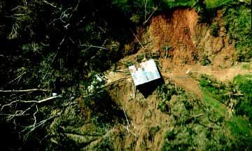ASSESSMENT AND CHARACTERIZATION OF DAMAGES Section 3 FIGURE 3-13 Severely damaged water treatment facility located in the floodplain in Jayuya; floodwaters overtopped the concrete wall. 3.3 Landslides Puerto Rico s steep topography and shallow, sandy soils over bedrock make it susceptible to landslides.