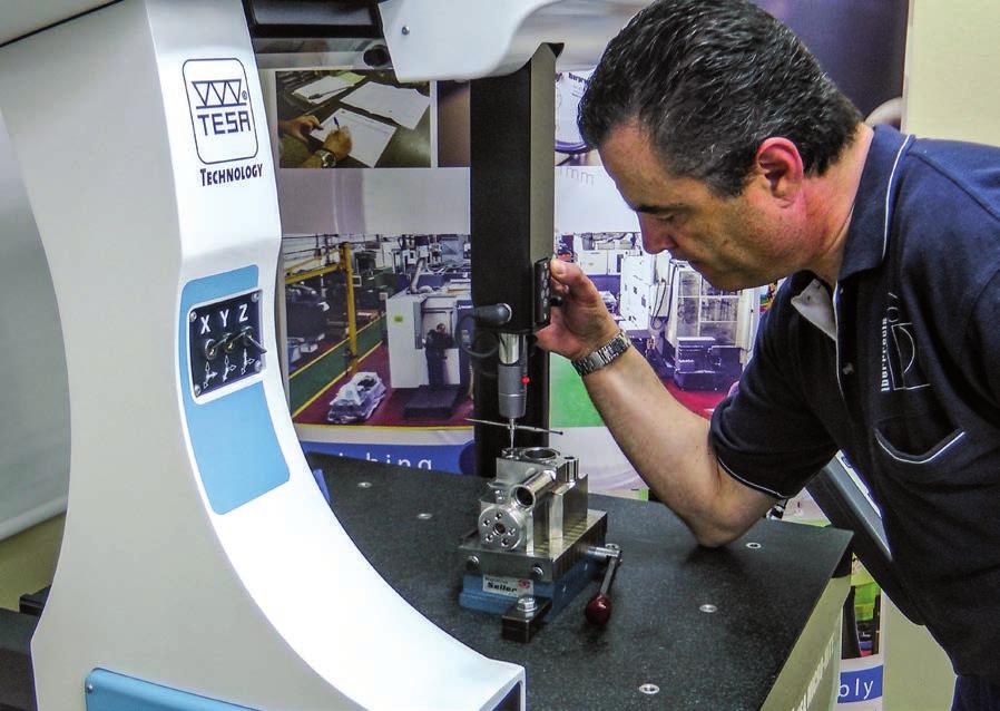 TWO-IN-ONE MACHINE Francisco Javier Lazaro, who has been with the company for 28 years, inspects machined parts on the MH3D DUAL, located in the gauge room.