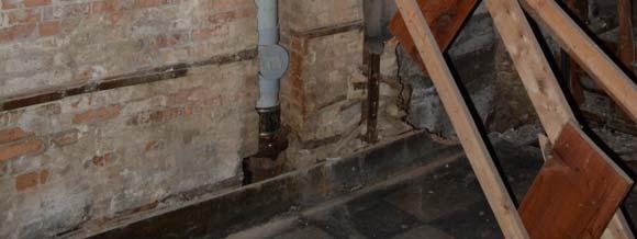 The header supporting the floor joists is heavily notched at one end and the trimmers on