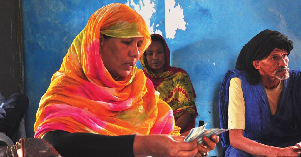 FAO/Aissata Lam Cash to restore food production and access Photo: A women receives her cash transfer in Monguel, Wilaya of Gorgol, Mauritania.