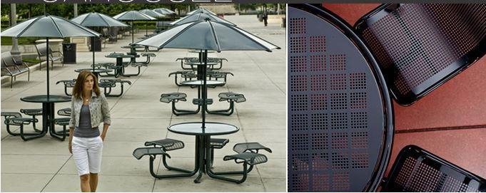 Table & Chair Units: Landscape Forms, Model # Carousel Steel Table with Steelhead perforated table top and perforated seats, polyester powder coat Bronze finish.