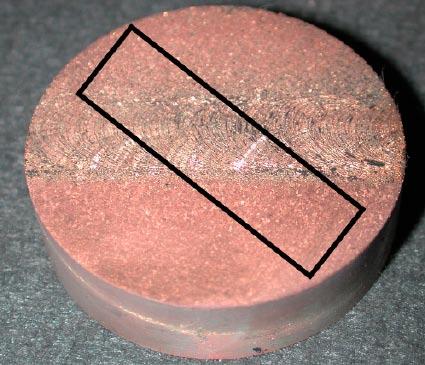 Figure 3-8. Exposed sample L013 revealing canister material and lid material.