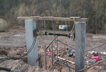 Test Setup: The test setup for the driven pile was more complicated. A jack was suspended from above to allow loading at a point 0.5-m. from the top of the piles (see Figure 8).
