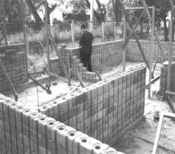 The blocks are pressed in special molds and normally stabilized with cement, see Fig. 7-11.