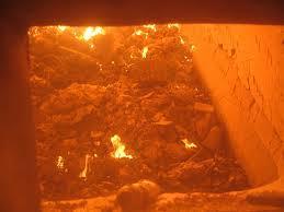 On the combustion grate in the incinerator (furnace), the main chemical reactions that convert the waste