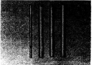 Figure 1.1: Fe based BMG rods with 1 and 2-mm diameters [31].