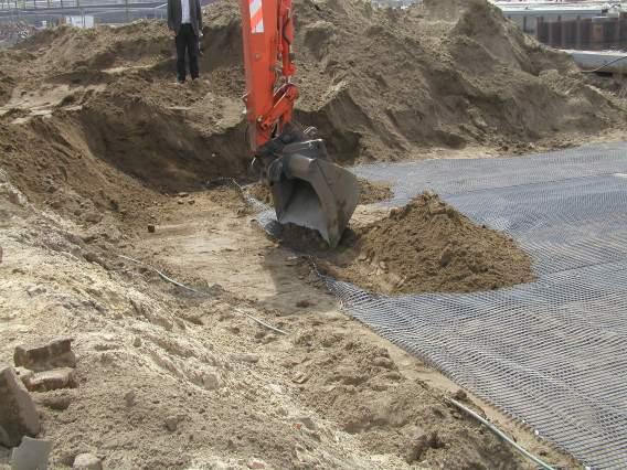 The reason for this extra length was to facilitate the prestressing of the geogrid by simply grapping and pulling it with the shovel of an excavator, Figure 3.