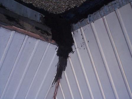 PHOTOGRAPH 22 Inadequate repairs completed with roofing cement at