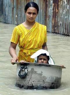 through floodwaters in Sirajgonj