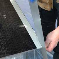 By applying a strip of masking tape to each front edge of the panel the cleaning off process is simplified with the tape pulled off once the silicone is dried.