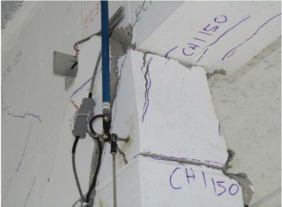 shear cracks at the bases of Wall 1 and Wall 3, and the crushing of the