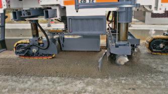 The trimmer, which is fitted with cutting tools arranged in a helical pattern, accurately sets grade for maximum concrete yield.