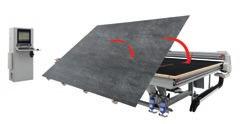 The machine operator manually positions the sheet of material on the tilting table.