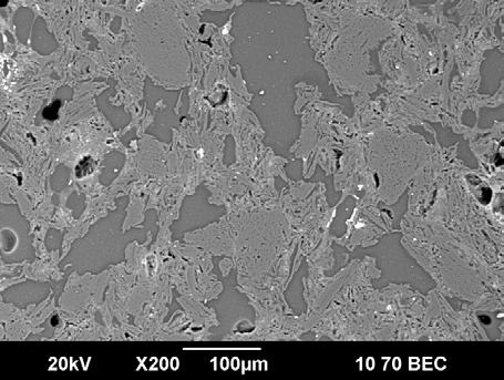 of somewhat rounded graphite particles and a more stringy binding carbon type. There was also another smooth carbon found in association with the stringy carbon.