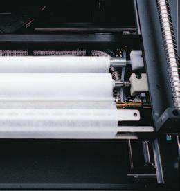 The paper-over-plenum design reduces maintenance by filtering out particles, while a constant-speed paper feeder minimizes paper consumption.