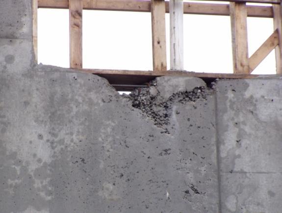 Finishing the Concrete V Incomplete consolidation leads to a rock pocket in the concrete wall. Note the exposed reinforcing bar. Unsound concrete will be removed and the area patched.