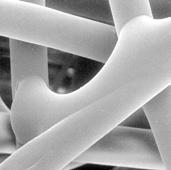 This dense layer of resilient uniform submicron fibers captures dust particles on the surface of
