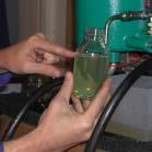 Place the oil container beneath the sampling valve. Open and close the valve five times and leave it open.