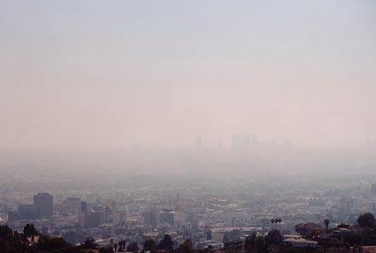 Smog Smog is a gray-brown haze formed by chemical reactions among pollutants released into the air by industrial processes and automobile exhaust. Ozone is one product of these reactions.